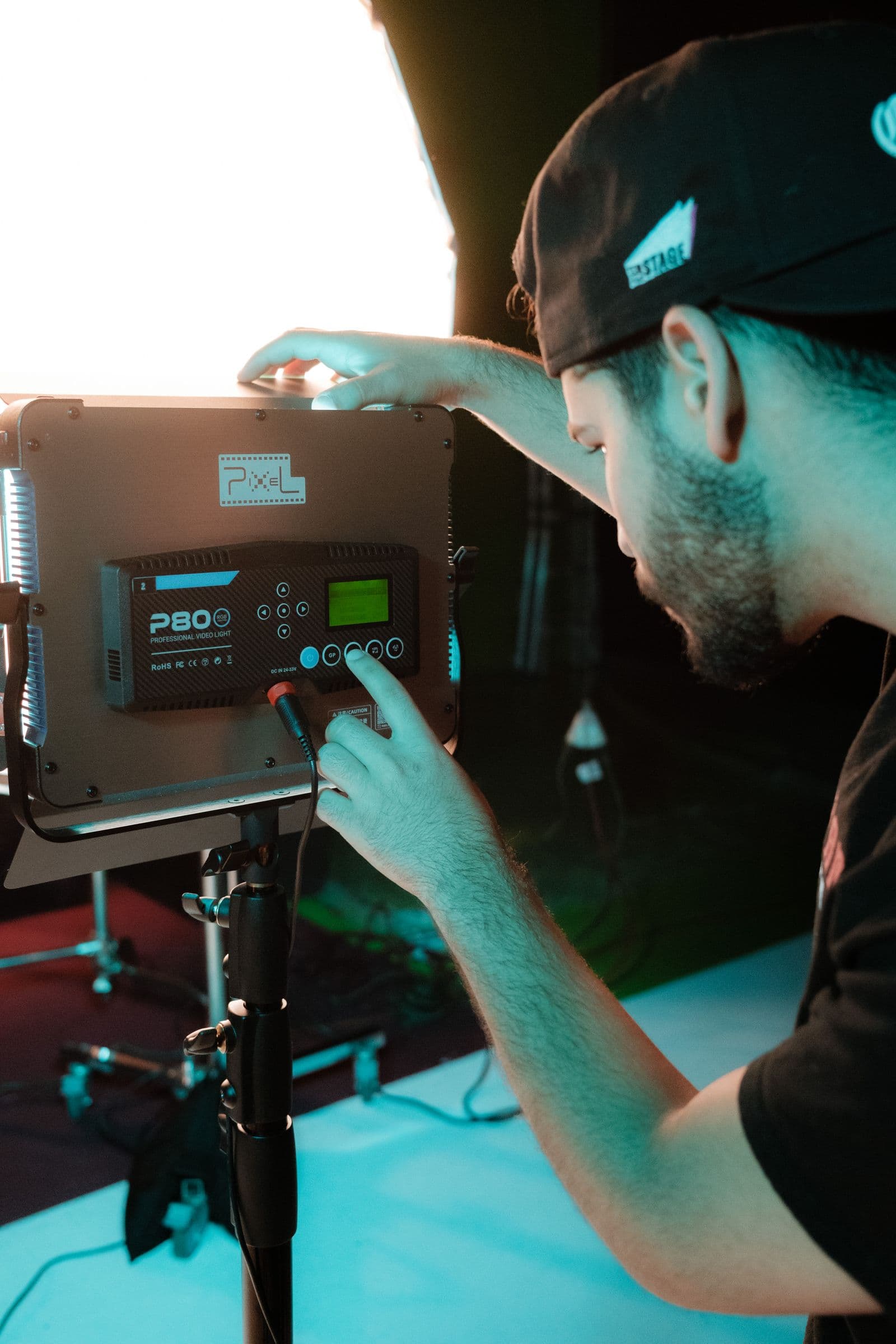 Technician adjusting an LED panel before a shoot