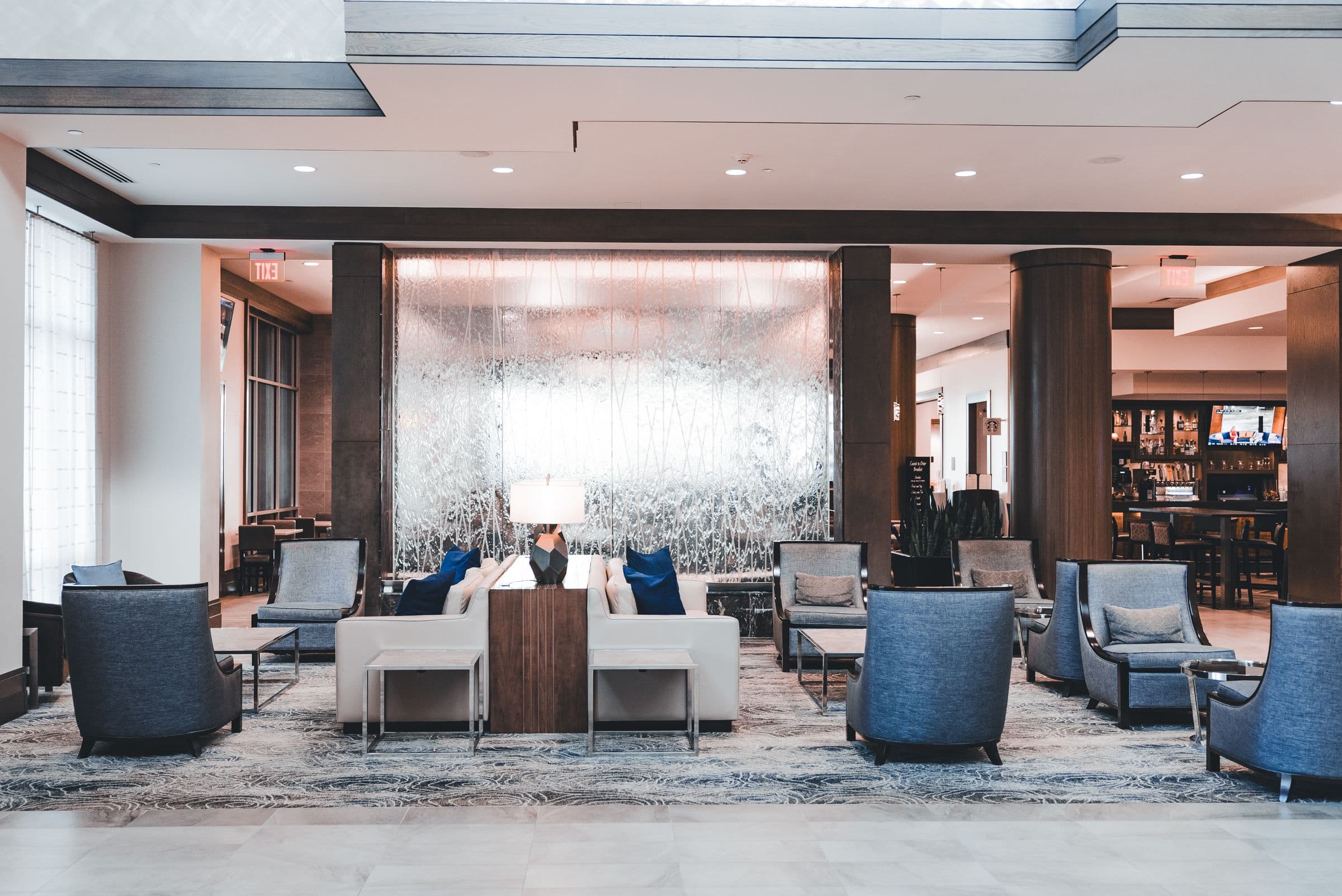 Hotel lobby lounge with low armchairs and warm lighting
